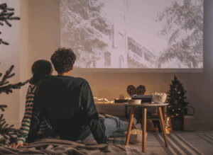 Couple sitting by Christmas Tree
